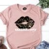 A pink t-shirt with a leopard print lip and the words " take me beauty ".