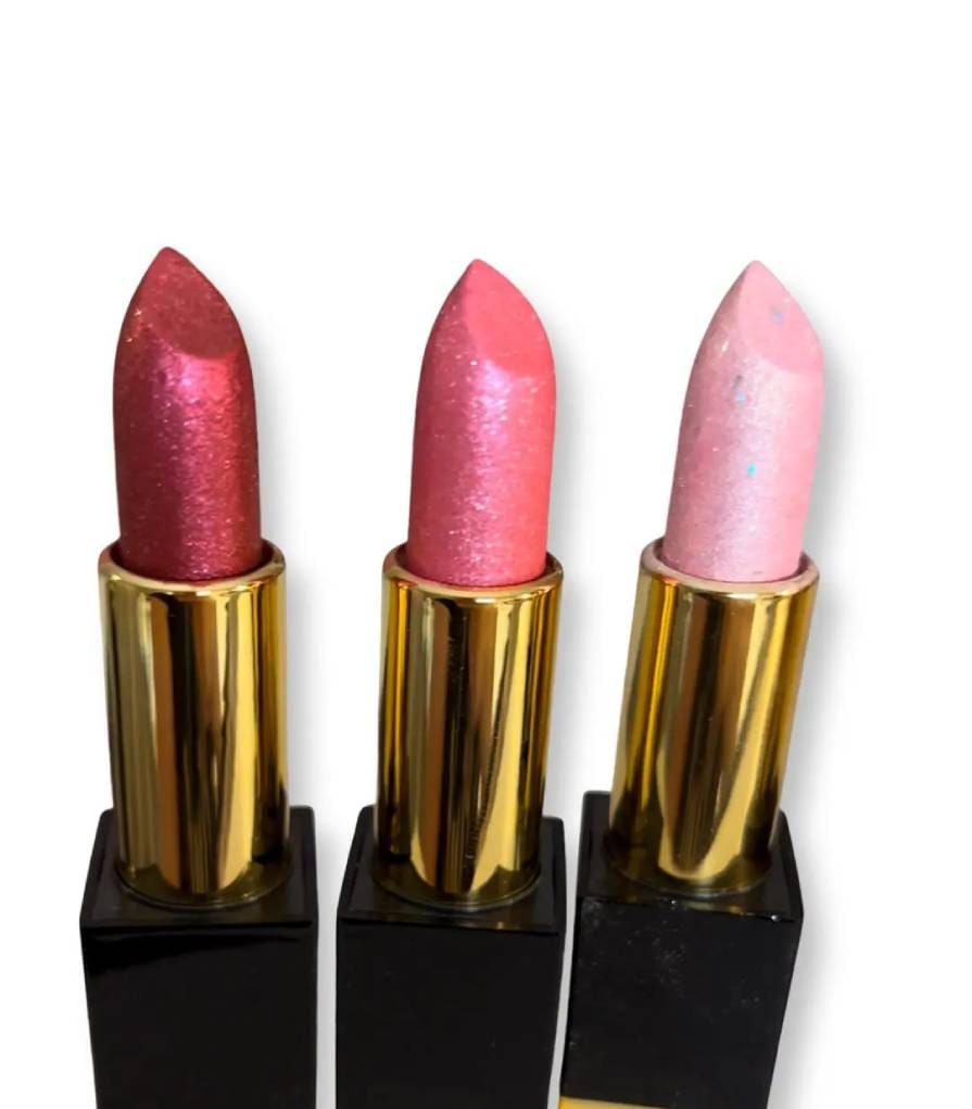 Three different colored lipstick on a black and gold box.