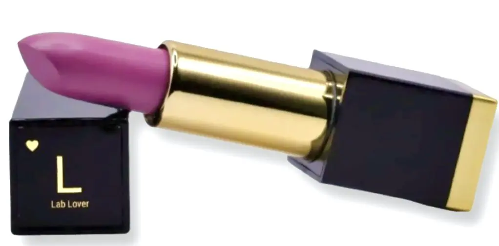 A pink lipstick is being held up to the side of a mirror.
