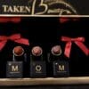 Three lipsticks are sitting on a shelf.