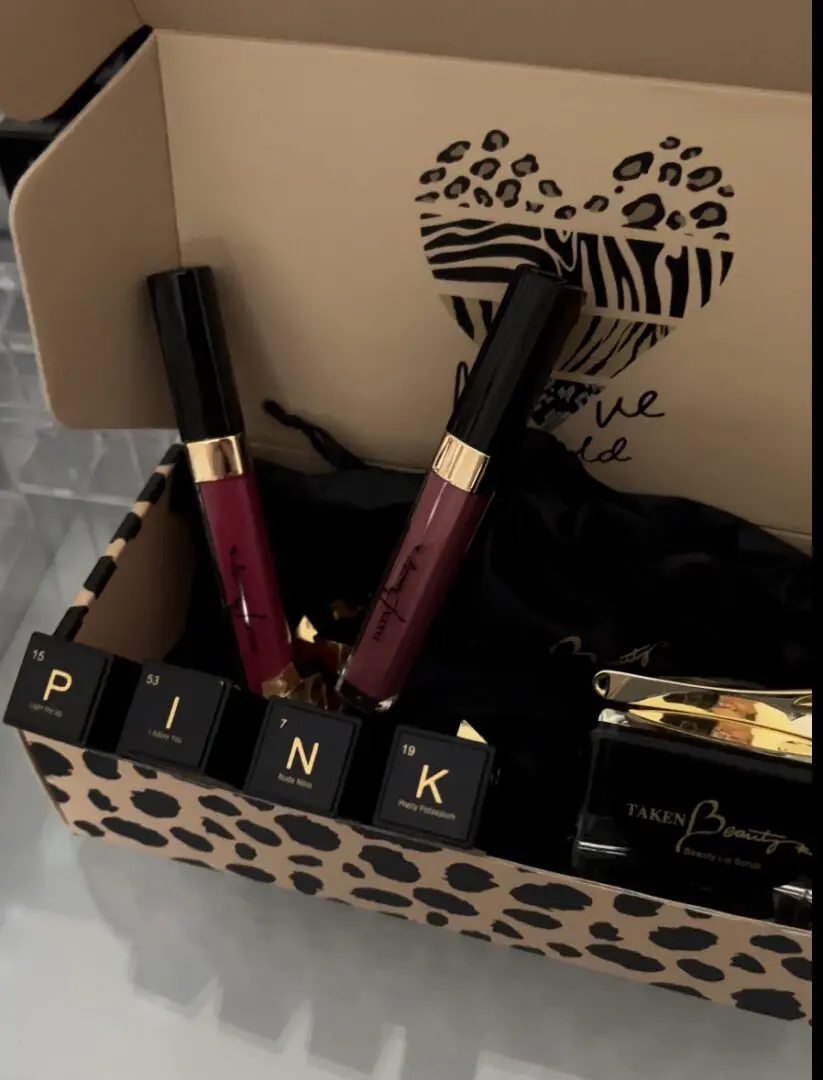 A box of lipstick and lip gloss with the word pink on it.