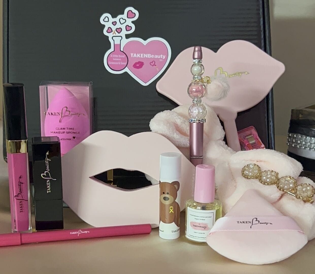 A table with some pink lipstick and other items