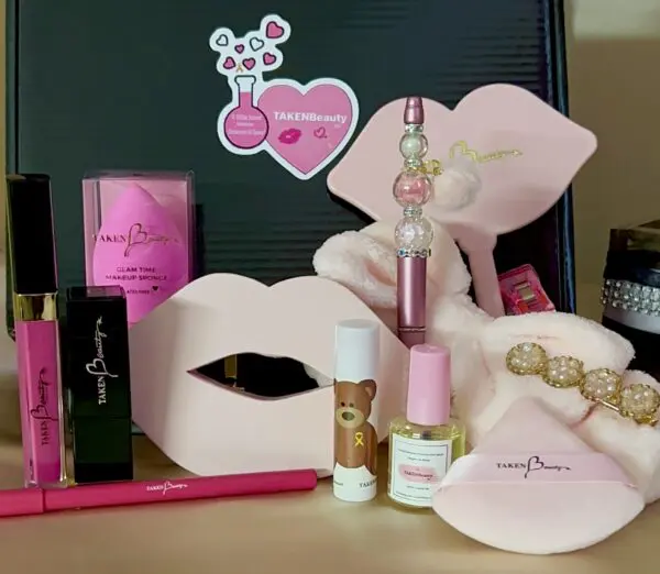 A table with lipstick, lip gloss and other cosmetics.