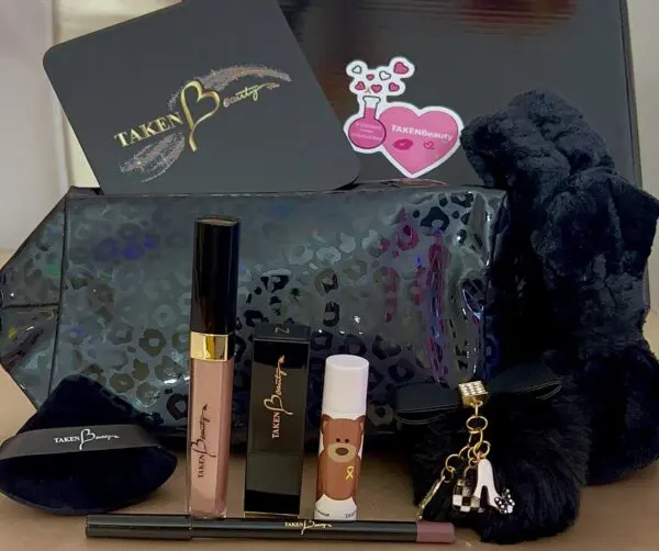 A black bag with some makeup and lipstick