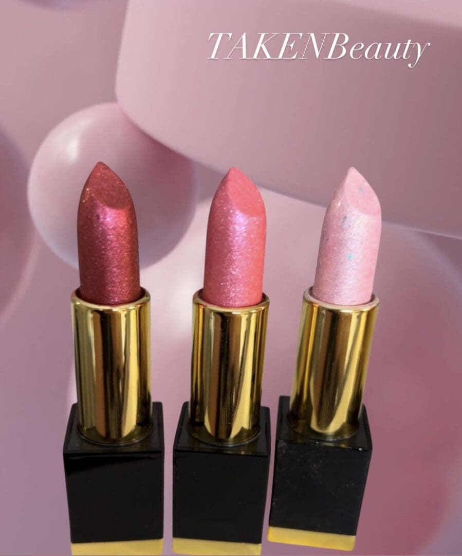 Three lipsticks are shown in a row.