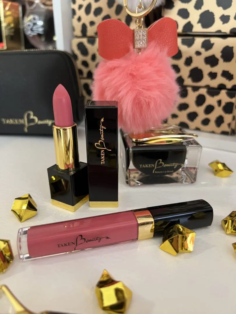 A table with some lipstick and other makeup products