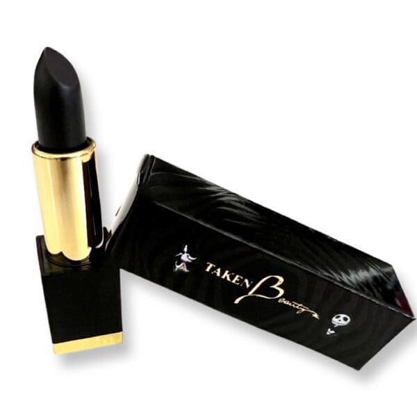 A black lipstick with gold writing on it.