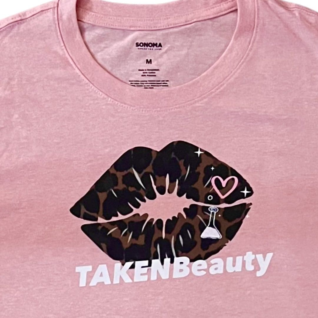A pink shirt with a brown and black lip design.