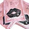 A group of pink shirts with black lips on them.