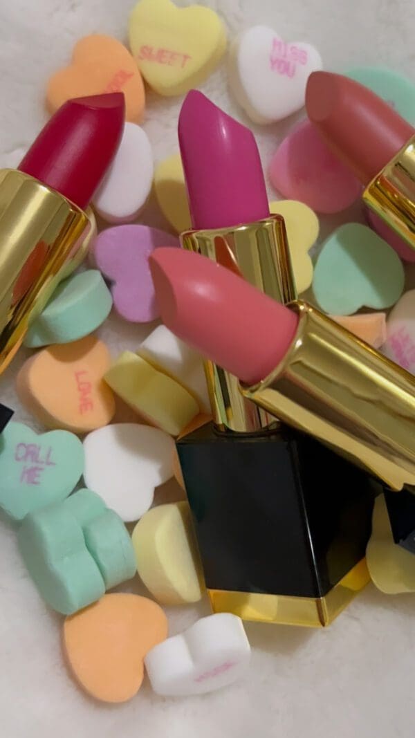 A close up of some lipstick on top of candy hearts