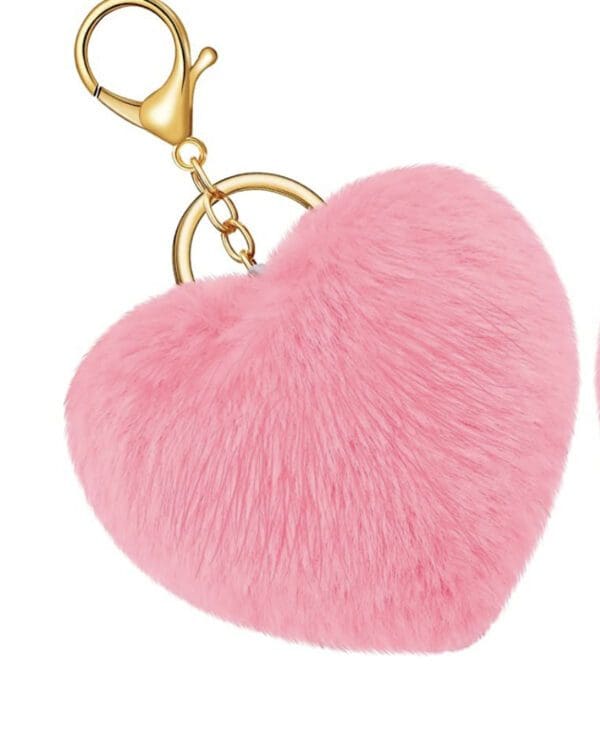A pink heart shaped keychain with gold colored metal chain.