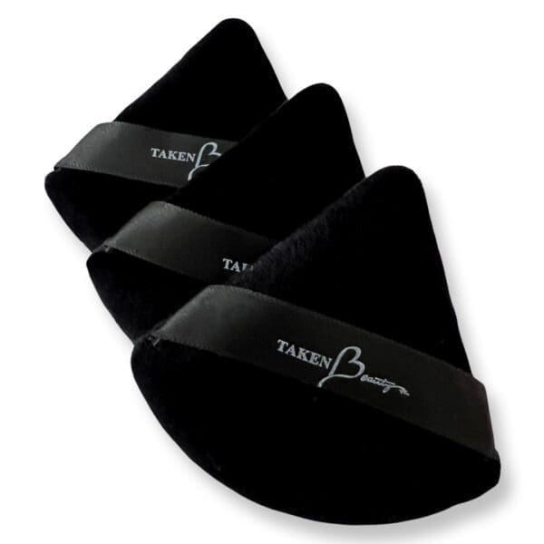 A set of three black triangular shaped pads.