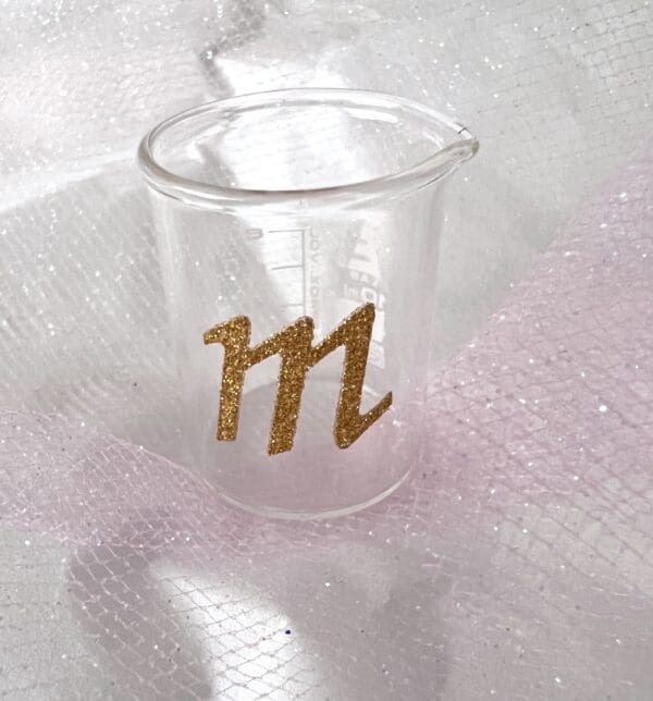 A cup with the letter m on it