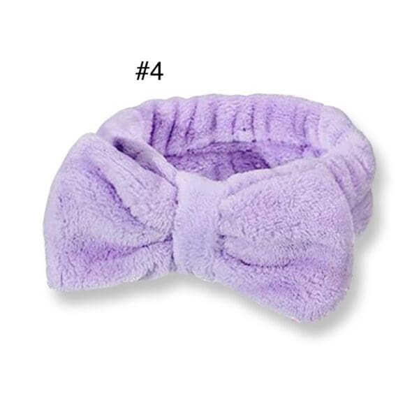 A purple bow tie is laying on top of the head.