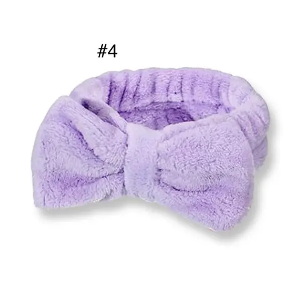 A purple bow tie is laying on top of the head.