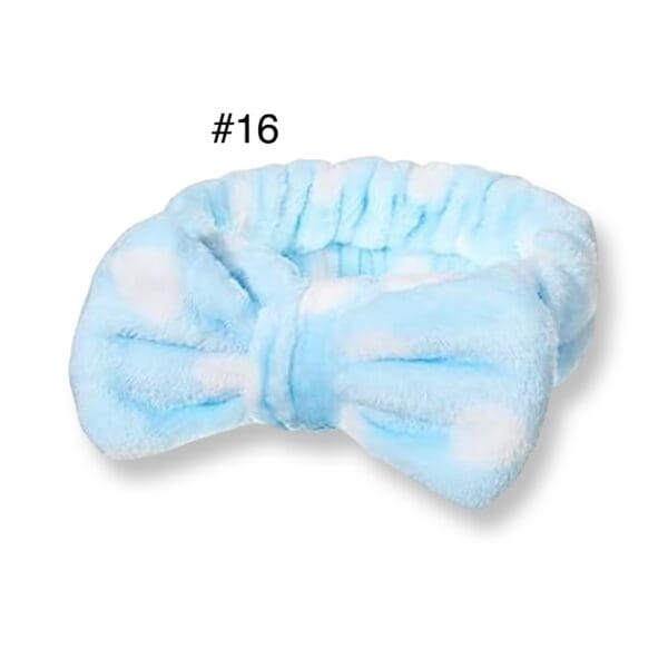 A blue bow tie is on top of the white towel.