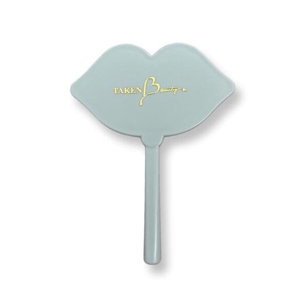 A light blue hand held mirror with the word " love " on it.