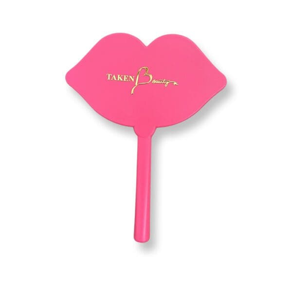 A pink hand fan with the word sassy on it.