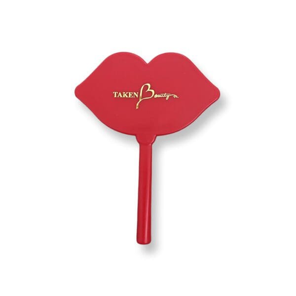 A red hand held mirror with the word " mary kay ".