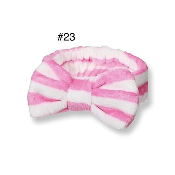 A pink and white striped bow tie headband.