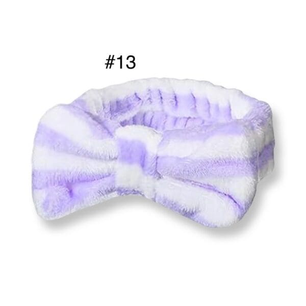 A purple and white striped headband with a bow.