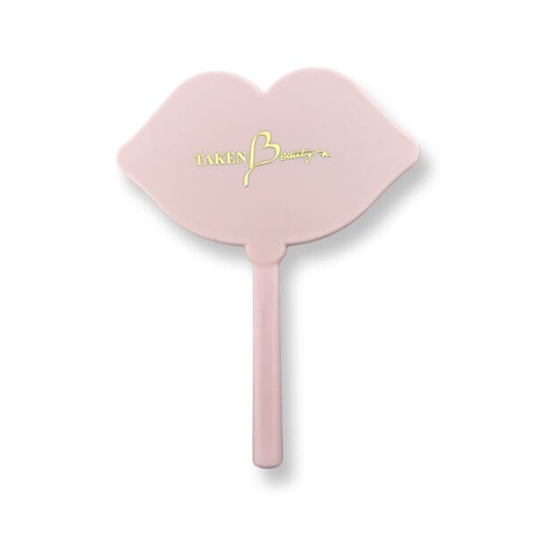 A pink hand fan with the word " lips " written on it.