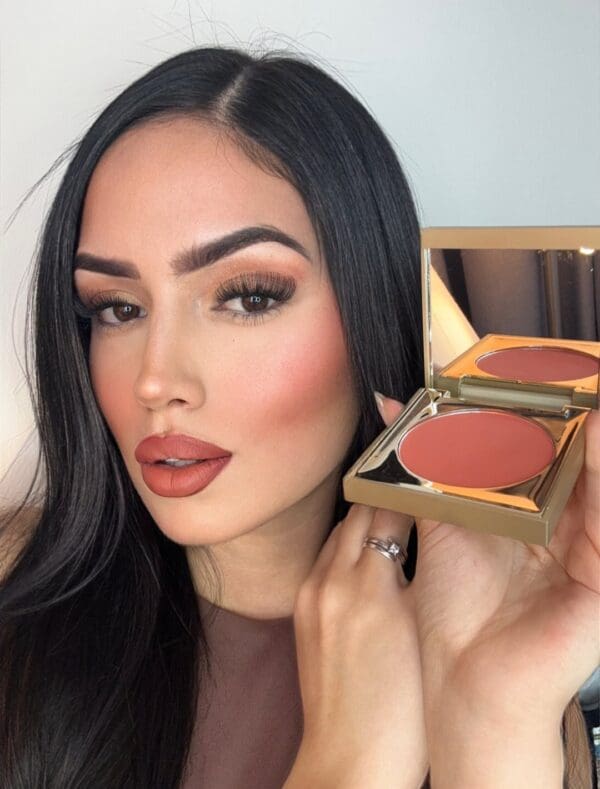 A woman holding onto a box of makeup
