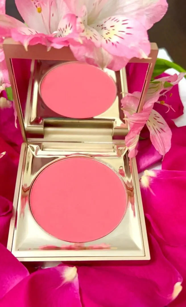 A close up of two pink powder compacts