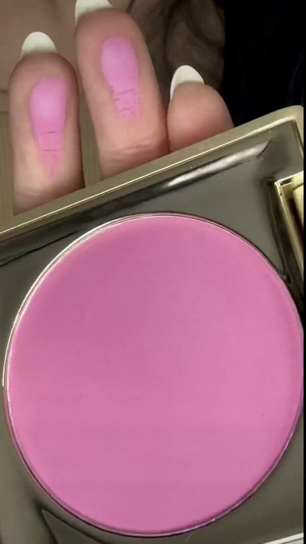 A close up of the top half of a pink powder.