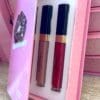 A pink box with two lipsticks in it