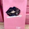 A pink bag with a picture of a lip on it.