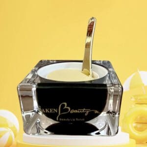 A black and white container with a gold spoon in it