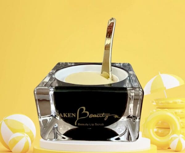 A black and white container with a gold spoon in it