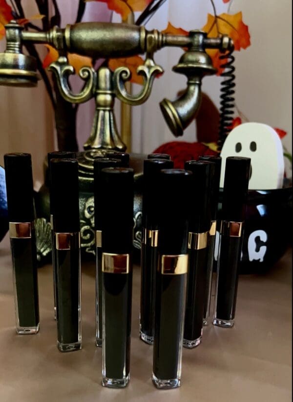 A table with many black lipsticks on it